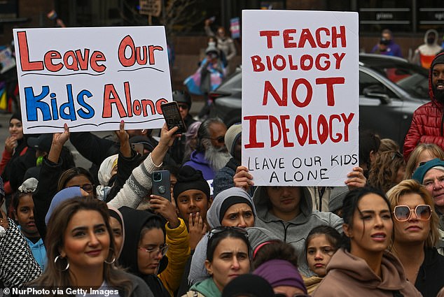 Protesters are pictured in Calgary on September 20 raising concerns about gender education in schools