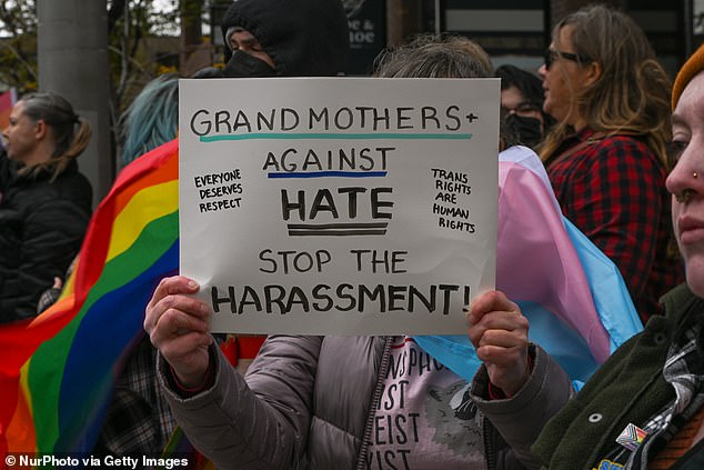 Members of the LGBTQ2+ community and allies stand in opposition across the street from the Million March 4 Children rally in downtown Calgary on September 20