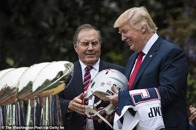 Belichick presents a Patriots helmet to then-President Donald Trump during a visit to the White House