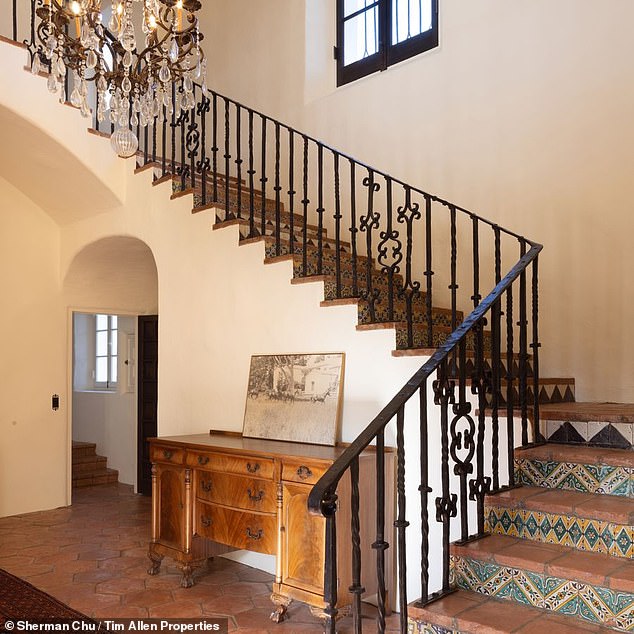 The recently renovated house retains much of its original character, including the Spanish influence - seen here in the tiles on the stairs and the arched doorways