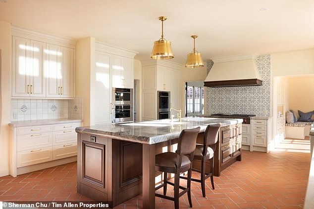 The kitchen in the property has recently been renovated but still shows the influence of the Spanish Revival in the bright tiles in the back wall and the rough, symmetrical brick floor design