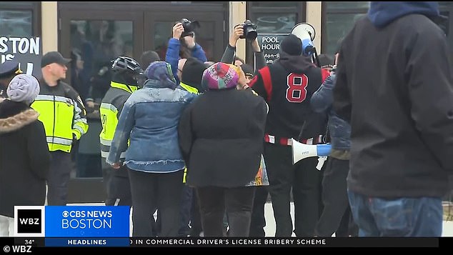 Protesters are seen outside the sports center on Wednesday, angry at being turned away