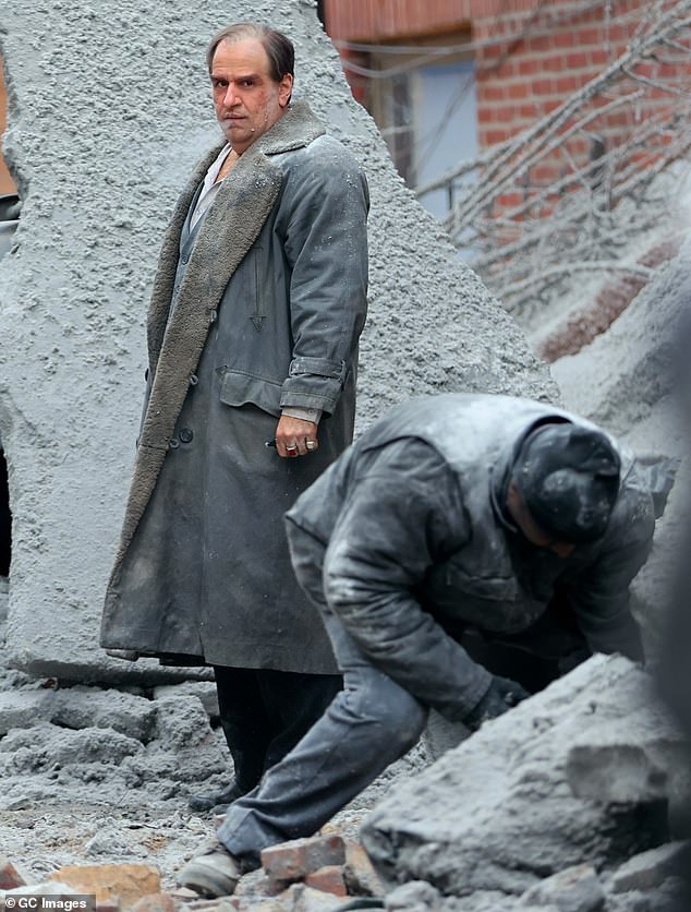 Colin kept warm in a large, matching gray coat that reached past his knees and had a faux fur lining