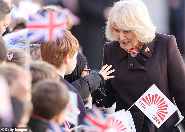 The king's wife, 76, was greeted today by hundreds of excited schoolchildren