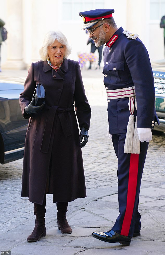 Queen Camilla is welcomed by Lord-Lieutenant of Somerset Mohammed Saddiq during a visit to the St John's Foundation Courts at the Chapel of St Michael Within