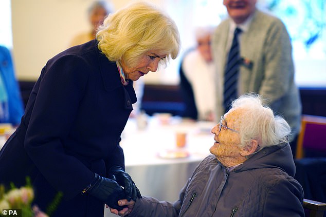 The King's wife, 76, wrapped warmly in a navy blue coat, leather gloves and chic knee-high boots for her visit to the charity's court at the Chapel of St Michael Within, which is in the courtyard of St John