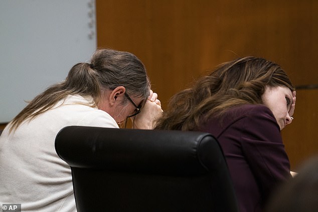 The mother held her head in her hands and refused to look at a screen showing Ethan Crumbley's final diary entries to jurors