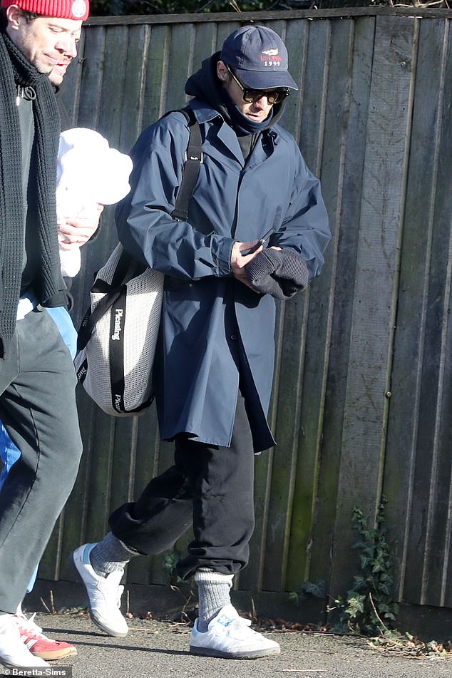 Harry dressed warmly as he left for sunny London