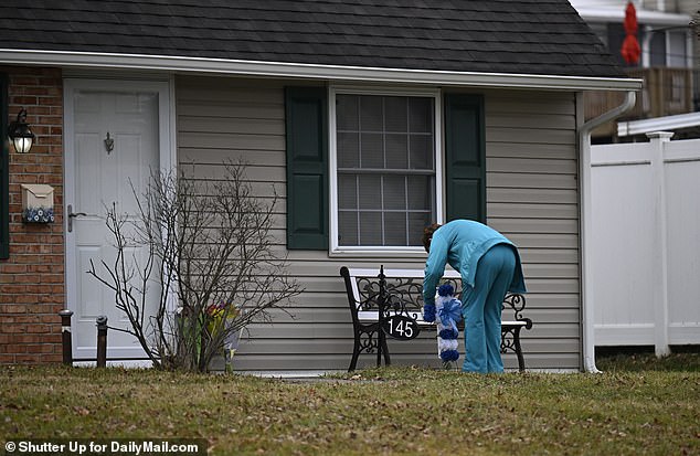 On Thursday, a woman was seen placing a cross of flowers in front of the Mohn Home