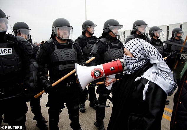 Protesters face off against police during a ceasefire rally in Gaza, outside Biden's event