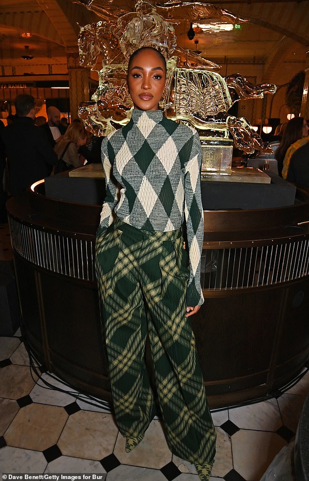 Jourdan Dunn looked stylish in a green patterned sweater and wide leg pants