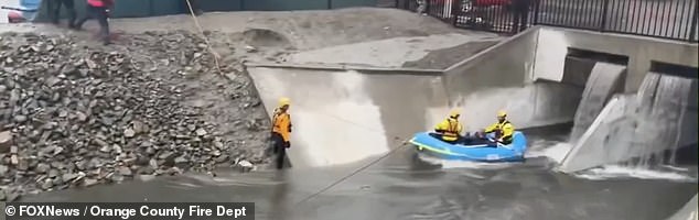 In Costa Mesa, a swift water rescue team pulled someone from a moving storm channel