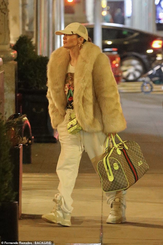 The star also accessorized with a small mint Valentino bag and a Gucci duffel bag with monogram 'JLO'