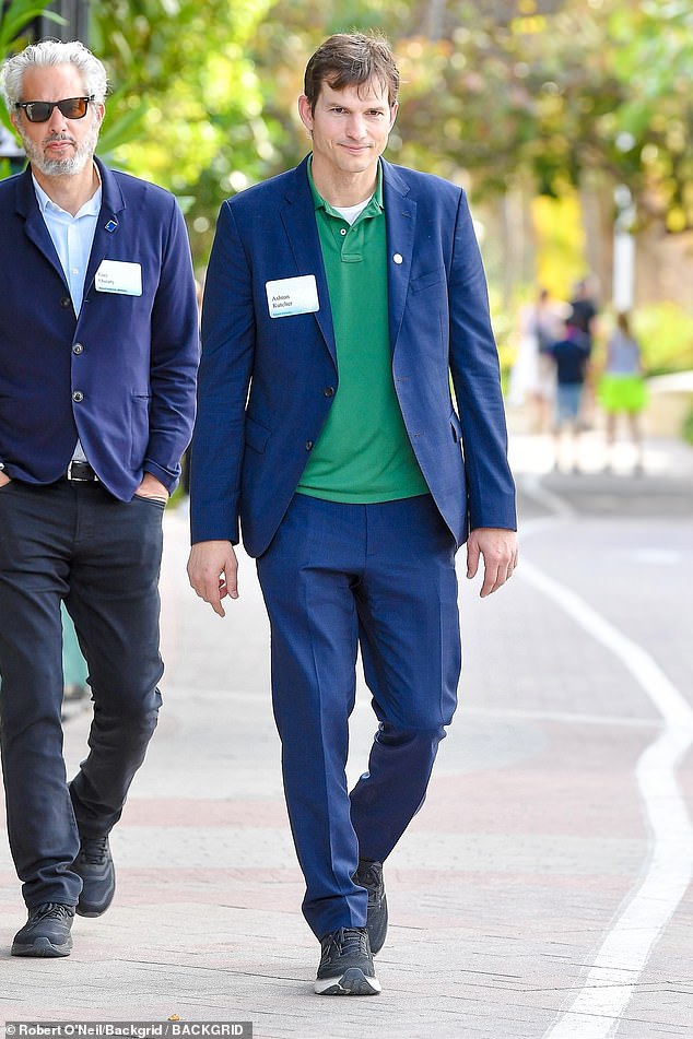 Ashton Kutcher wore a sleek blue suit, a casual green top and sneakers