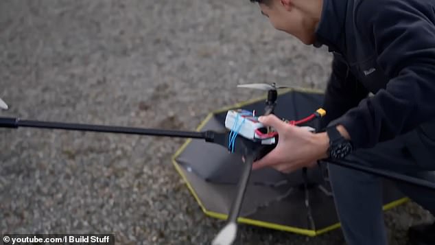 Although he has to control the umbrella to keep it above his head as he moves, he imagines an autonomous machine that can intelligently follow him