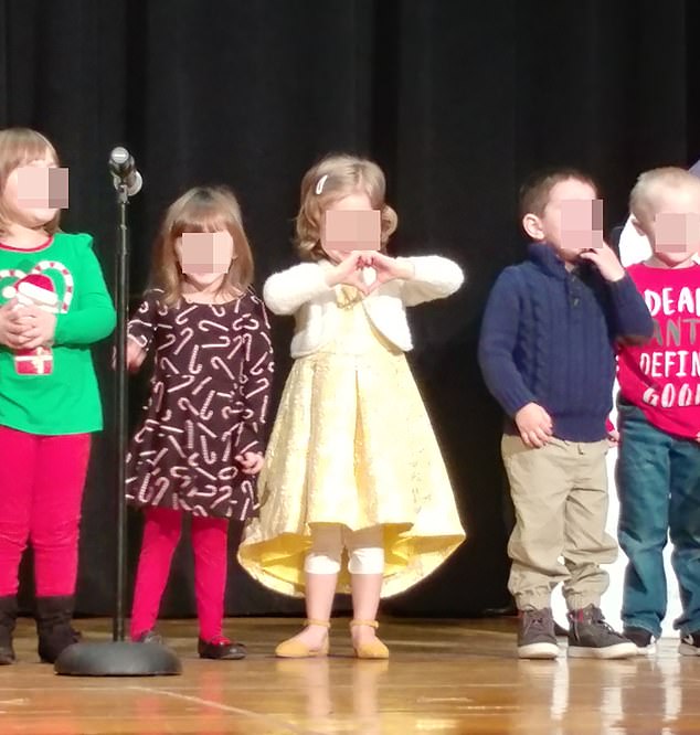 Matthew (center) during a holiday parade, four years old, dressed as a girl