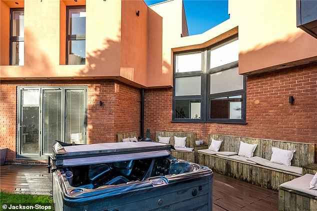 Outside, in the backyard, there is room for ample seating and a hot tub