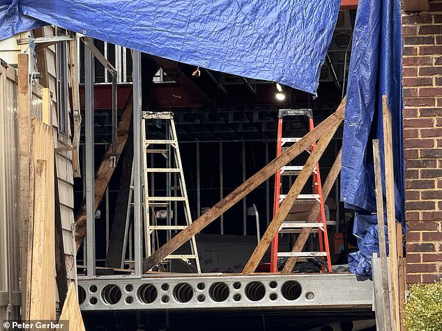 The building was covered with a blue tarpaulin and scaffolding was erected.  Photos show it was visible with ladders and wooden planks on the second floor