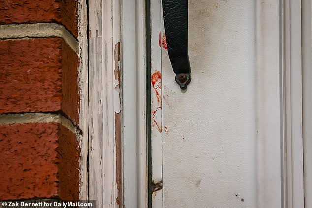 Bloody fingerprints can be seen on the front door of a royal home where a man caused a stabbing attack