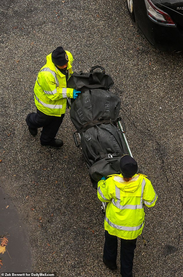 City workers remove bodies from a Queens home where a man allegedly committed a stabbing