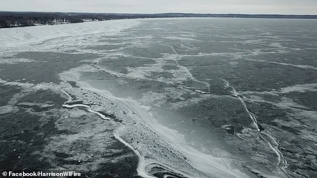 Footage shows multiple, deeper cracks overlapping in the lake as the drone moves further away from shore