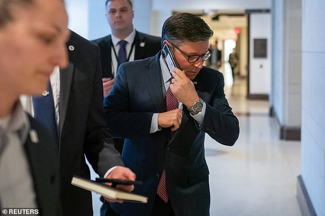 Speaker Johnson seen on his phone on Capitol Hill.  His staff has pushed back against a New York Times report suggesting he takes phone calls to avoid talking to the media.