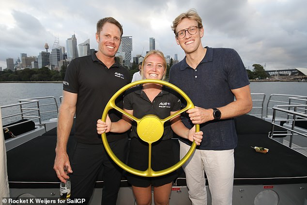 Mack Horton (right) posed next to the trophy with Australian SailGP team grinder Sam Newton (left) and strategist Tash Bryant (center)