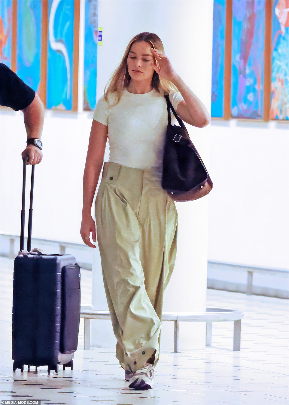 They wheeled her bags through the terminal to a vehicle awaiting her arrival