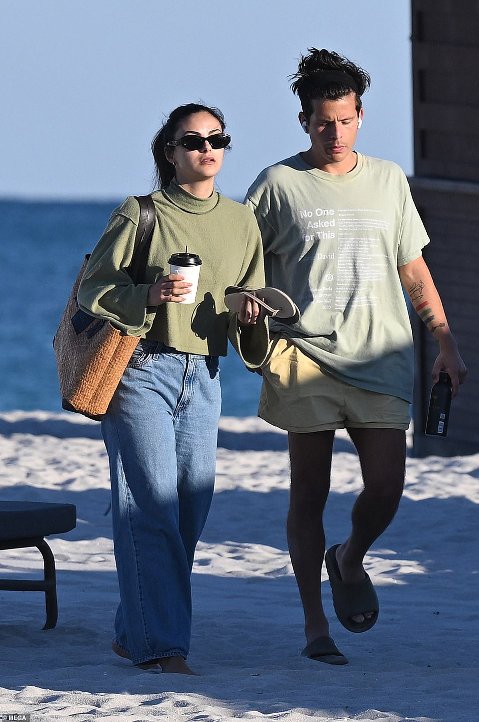 They were later spotted leaving the beach and Camila donned baggy jeans and a green faux turtleneck with long sleeves.