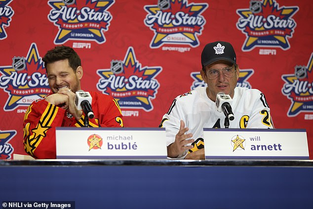 Fellow co-captain Will Arnett jokes with Buble during a press conference on Thursday