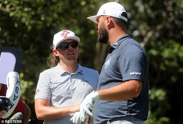 Rahm chats with fellow LIV star Cameron Smith as they prepare for their first round