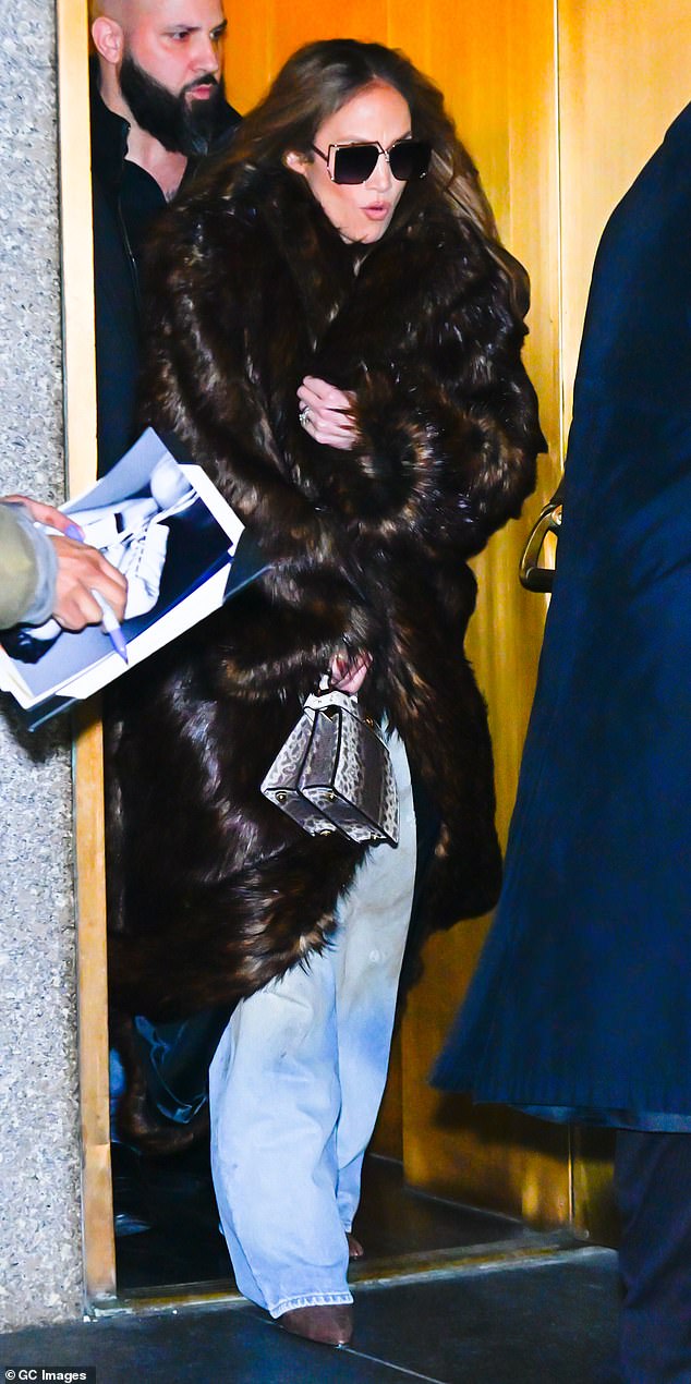 Jennifer braced herself for the cold as she left a building