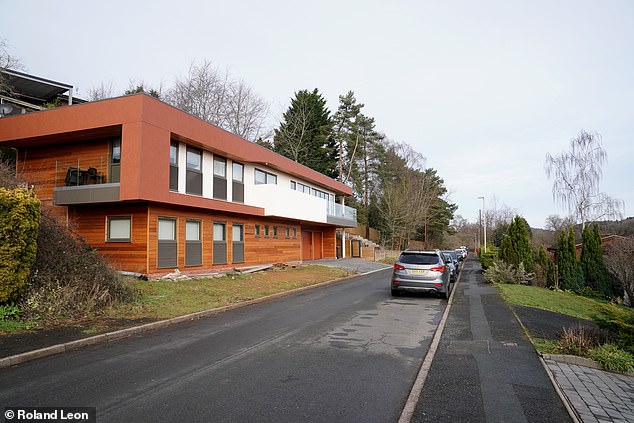 Local Glenn Jackson called the modern house (pictured, left) 'a brutal structure and totally foreign to the area'