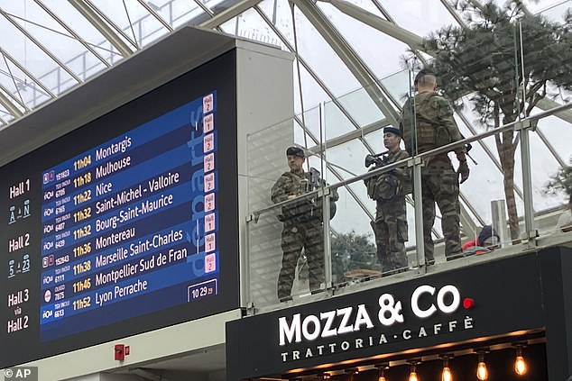 French soldiers watch over passengers at Gare de Lyon train station in Paris after a knife attack