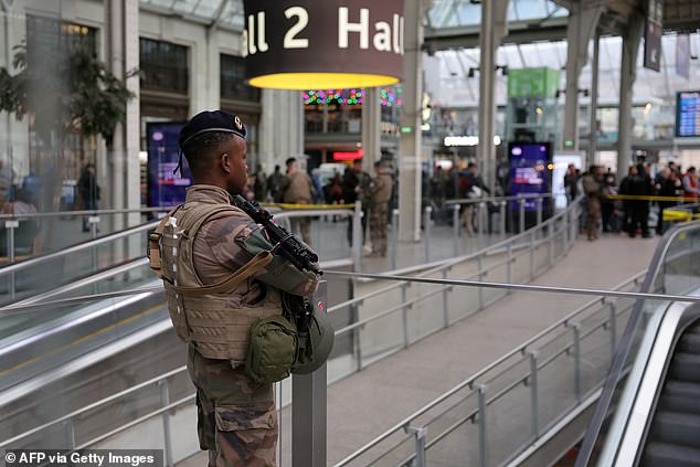 A French soldier from the Sentinelle security operation stands guard in a hall after a knife attack at the Gare de Lyon train station in Paris