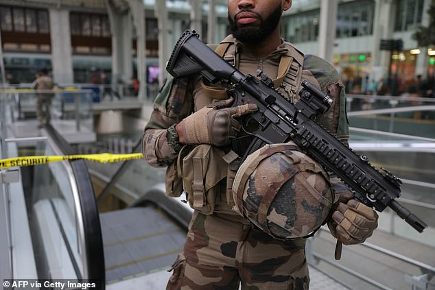 A French soldier from the Sentinelle security operation stands guard in front of a security perimeter after the brutal, barren attack