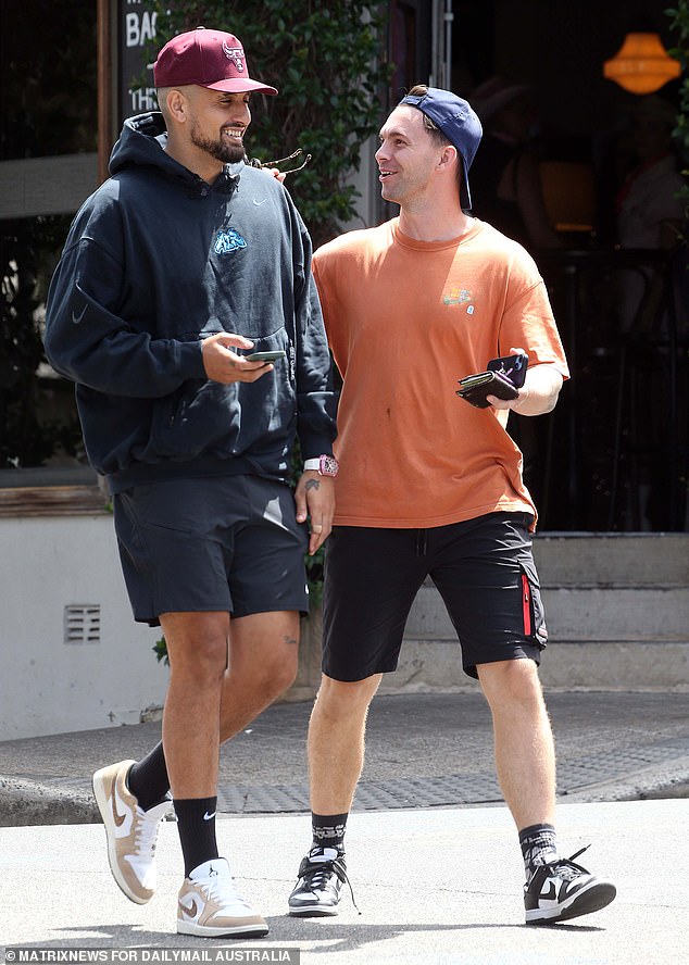 Nick happily walked along with his friend and chatted as the pair laughed as they walked