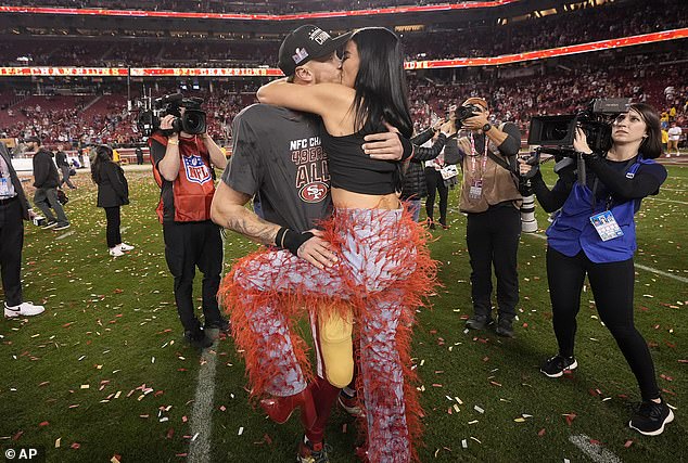 The couple kissed after the 49ers defeated the Lions and booked a trip to the Super Bowl