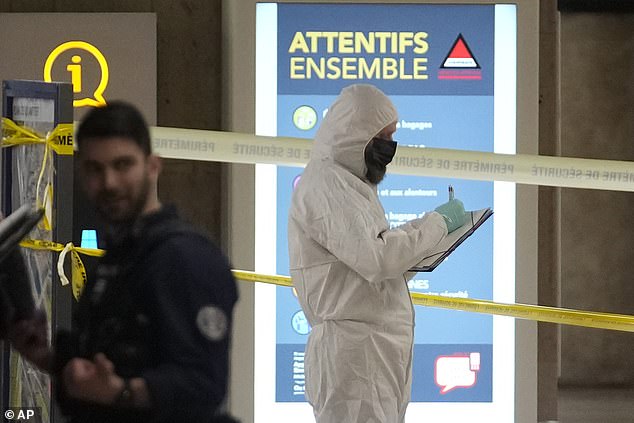 Police investigators work at Gare de Lyon station after an attack earlier today