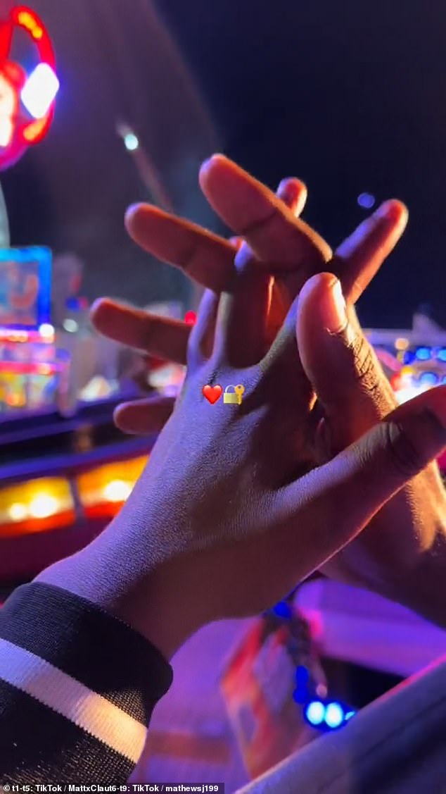 Mateus Johannes, 28, and Claudia Kambanza, 22, hold hands at the fair