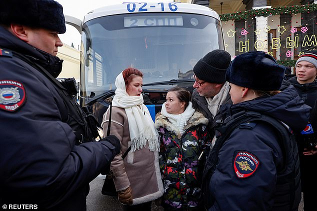 Members of the 'Way Home' movement are surrounded by police officers in central Moscow