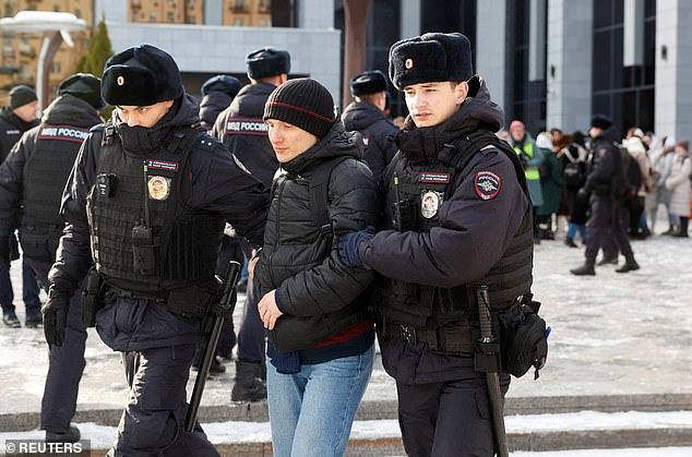 A demonstrator is arrested by police on Saturday during protests in the Russian capital