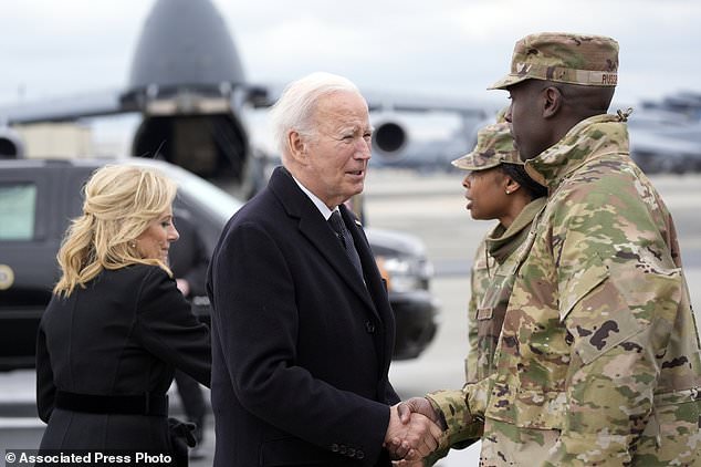 President Joe Biden and first lady Jill Biden greet service members before boarding Air Force One after attending a casualty return for the three service members killed in the attack