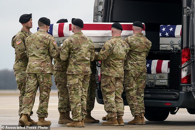 An army transport team loads the transfer case with the remains of the three military servicemen, whose deaths have sparked several waves of retaliatory attacks