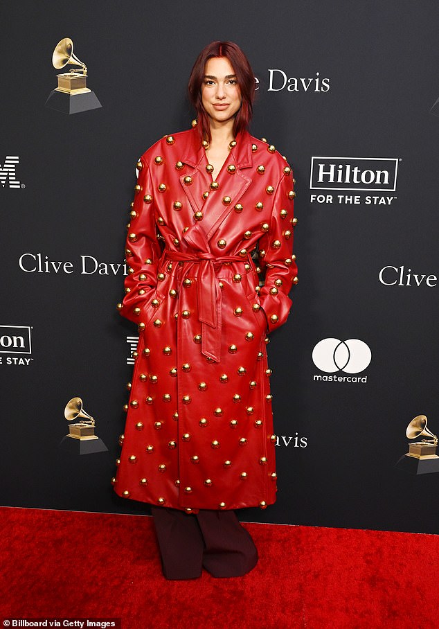 Her burgundy locks were tucked into the collar of her jacket and matched the color of her baggy pants