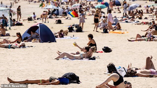 Beachgoers in Melbourne are pictured as temperatures soar