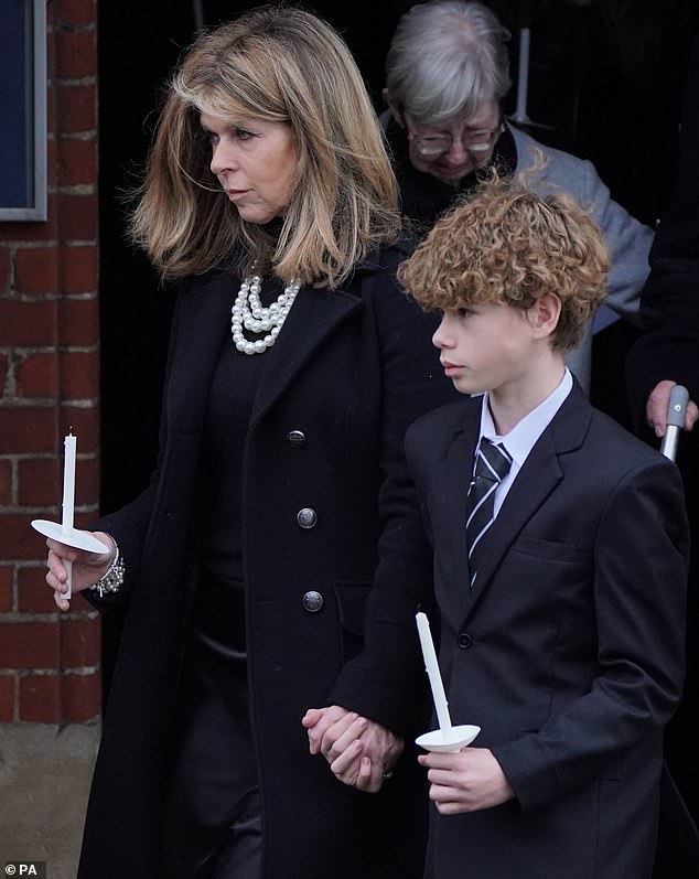 Kate leaves the funeral service, which was held on Friday afternoon, holding her son William's hand