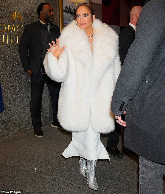 The singer - who survived a hair accident earlier in the evening - covered her toned body with a fur coat worn over a flowing white dress.