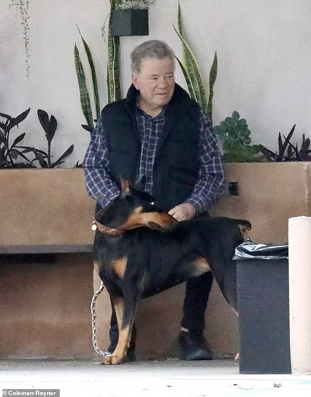 The dog lover arrived early at a local veterinary clinic and sat outside while he waited for the clinic to open, exclusive photos from DailyMail.com show