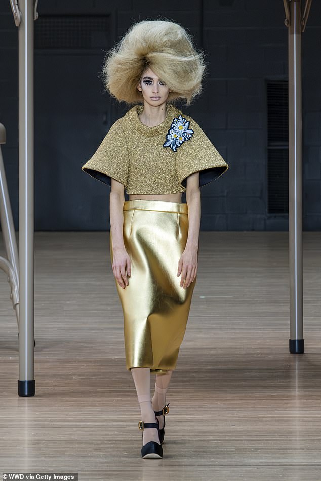 GOING FOR GOLD: A gold-clad model with a blue flower brooch